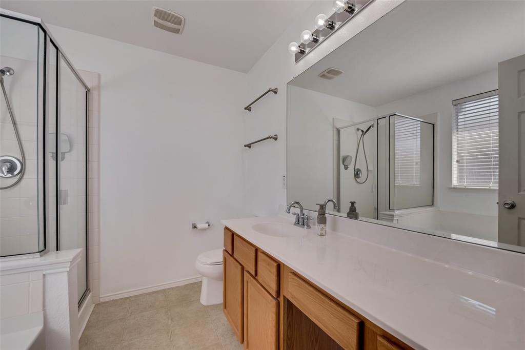 315 Red Oak Court Forney, TX 75126 - Photo 12 of 15 a bathroom with a sink a toilet and shower