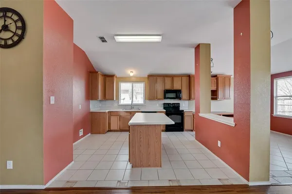 a large white kitchen with a large window