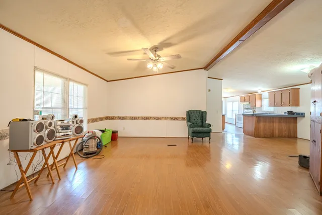a view of a kitchen with wooden floor and electronic appliances