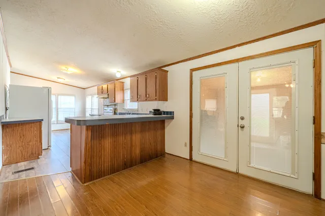 a kitchen with granite countertop white cabinets and white appliances