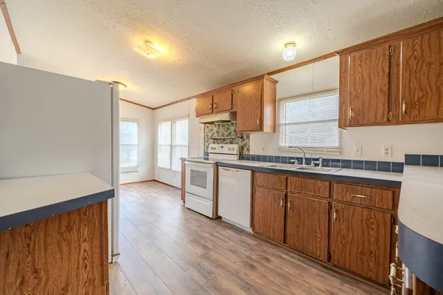a kitchen with stainless steel appliances a refrigerator and a stove top oven
