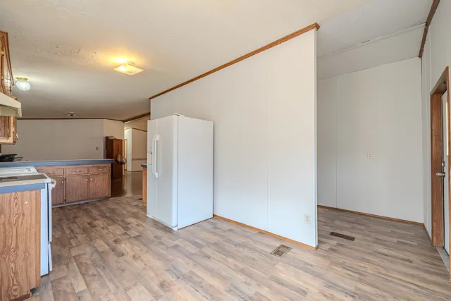 a view of a room with wooden floor