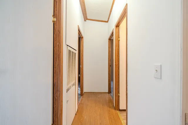 a view of a house with backyard and trees