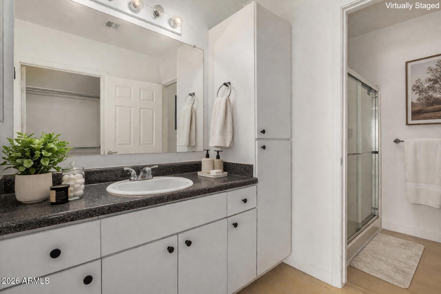 1295 North Ash Street, Unit 828 Gilbert, AZ 85233 - Photo 15 of 43 a bathroom with a granite countertop sink and a mirror