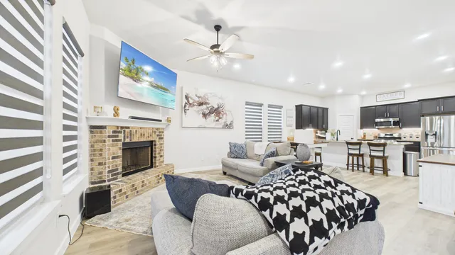 a living room with furniture fireplace and flat screen tv