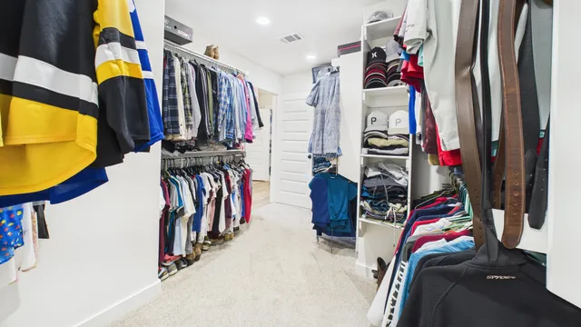 a view of walk in closet with clothes