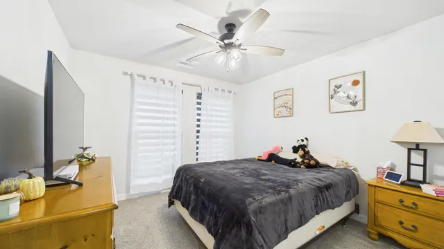 a bed room with a bed and a chandelier