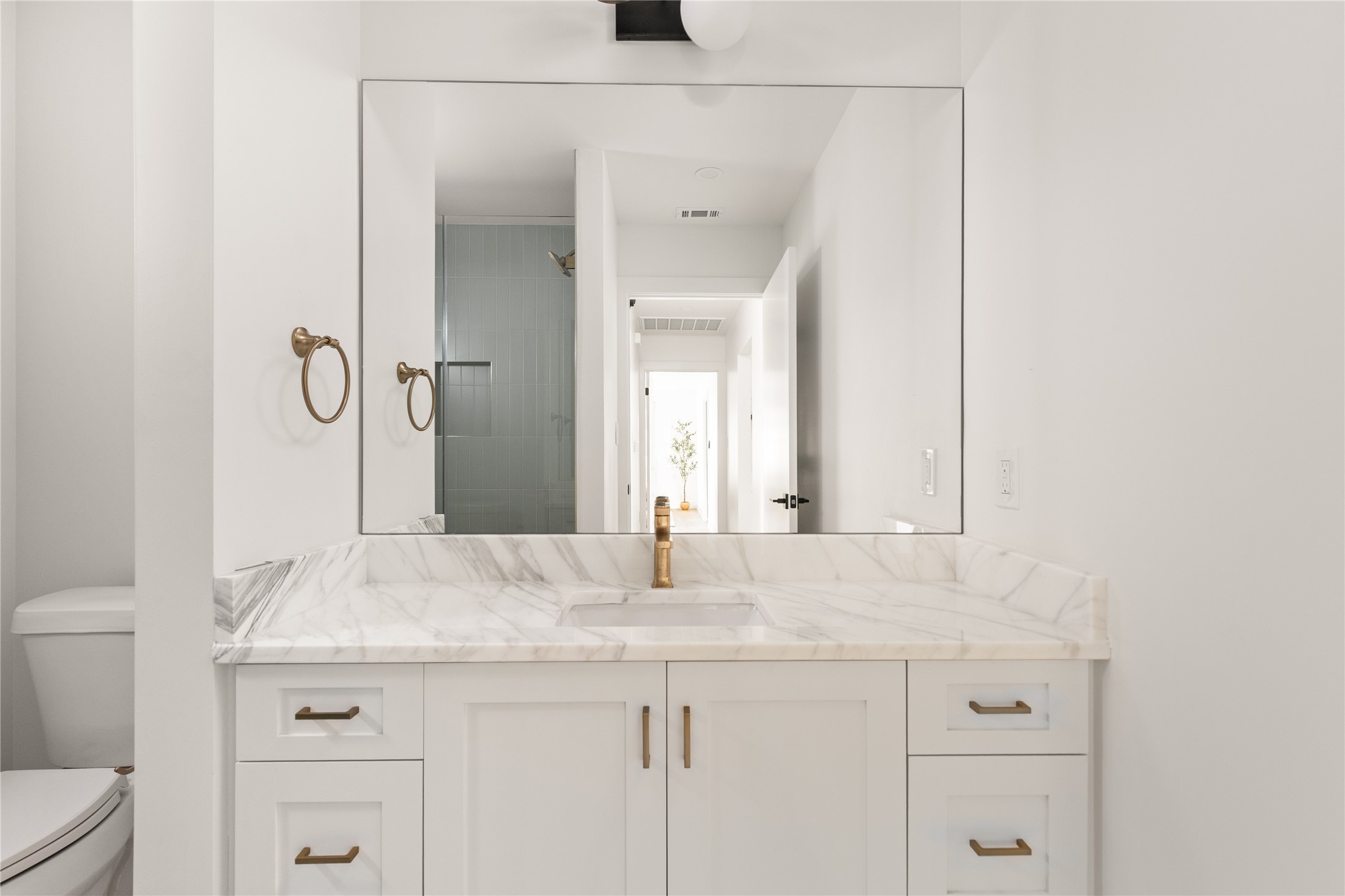 4501 Pack Saddle Pass Austin, TX 78745 - Photo 20 of 37 White vanity with gold-finish hardware and integrated sink