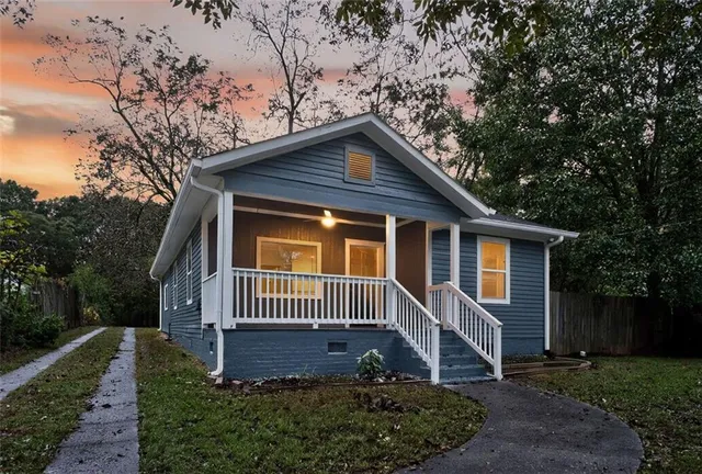 a front view of a house with a garden