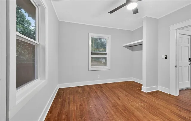 a view of a room with wooden floor and window