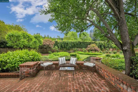 a view of backyard with seating area and green space