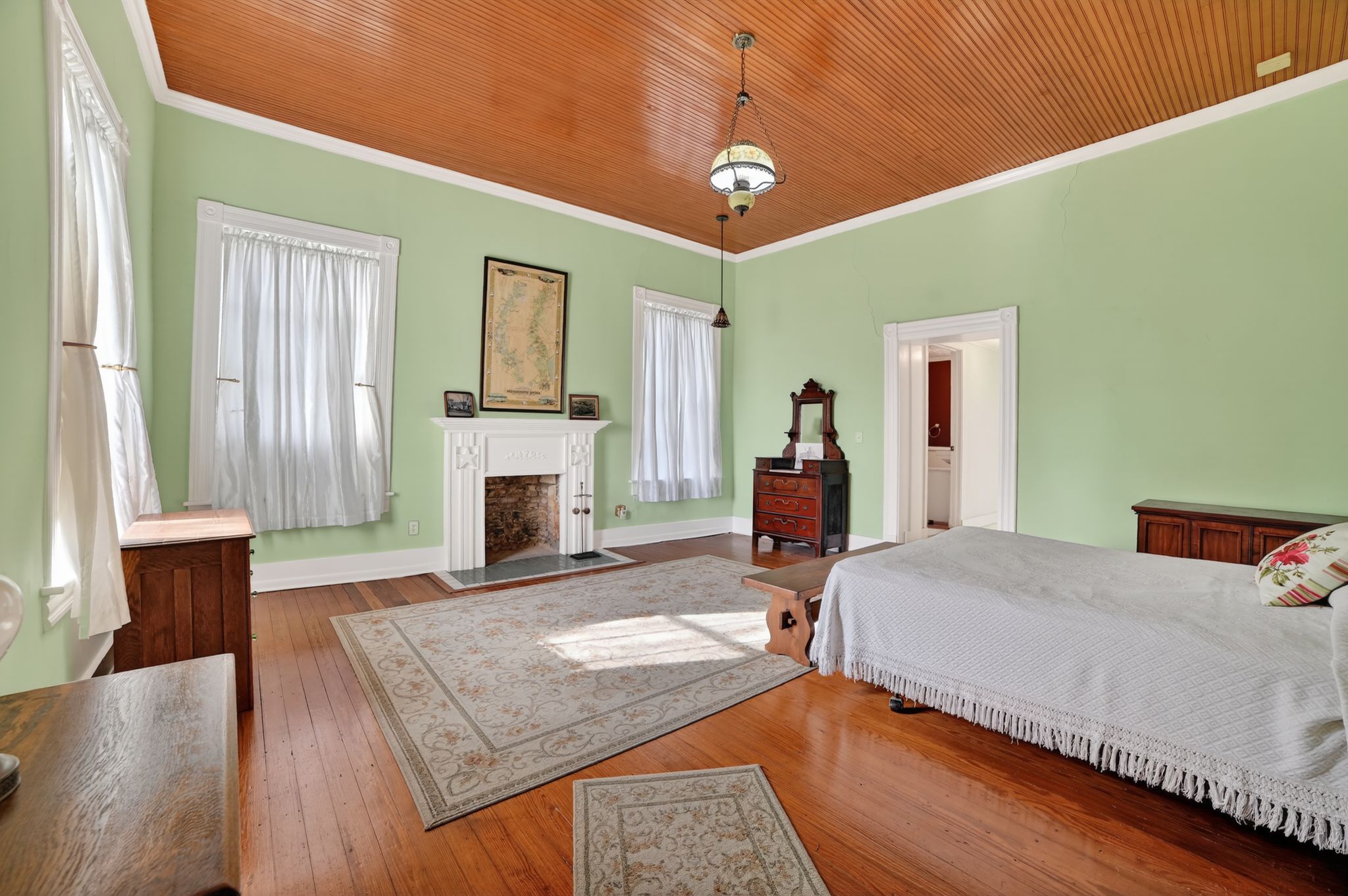 400 South Main Street Belton, TX 76513 - Photo 11 of 18 Bedroom with hardwood / wood-style flooring, a fireplace, crown molding, and wooden ceiling