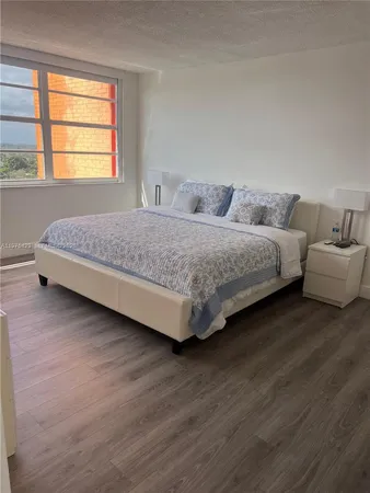 a bedroom with bed and window