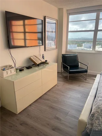 a workspace with a window and wooden floor