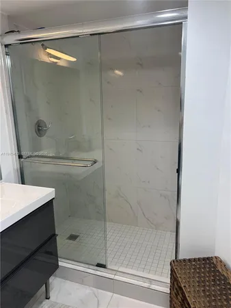 a bathroom with a shower and a sink