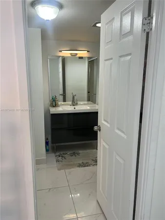 a bathroom with a sink and mirror