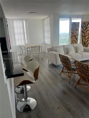 a living room with furniture and a large window