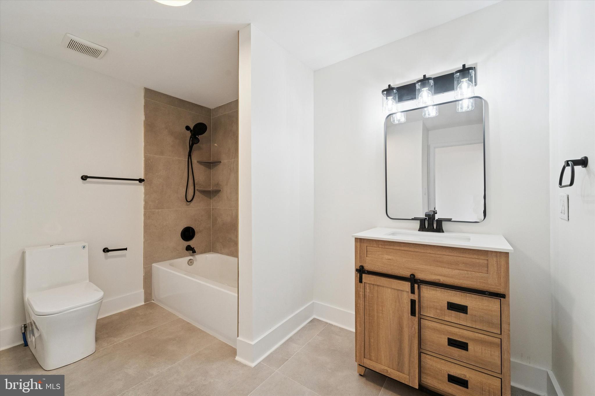 2353 East Huntingdon Street Philadelphia, PA 19125 - Photo 14 of 42 a bathroom with a sink a toilet and a mirror