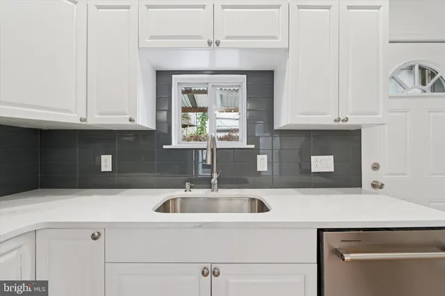 a kitchen with a sink and cabinets