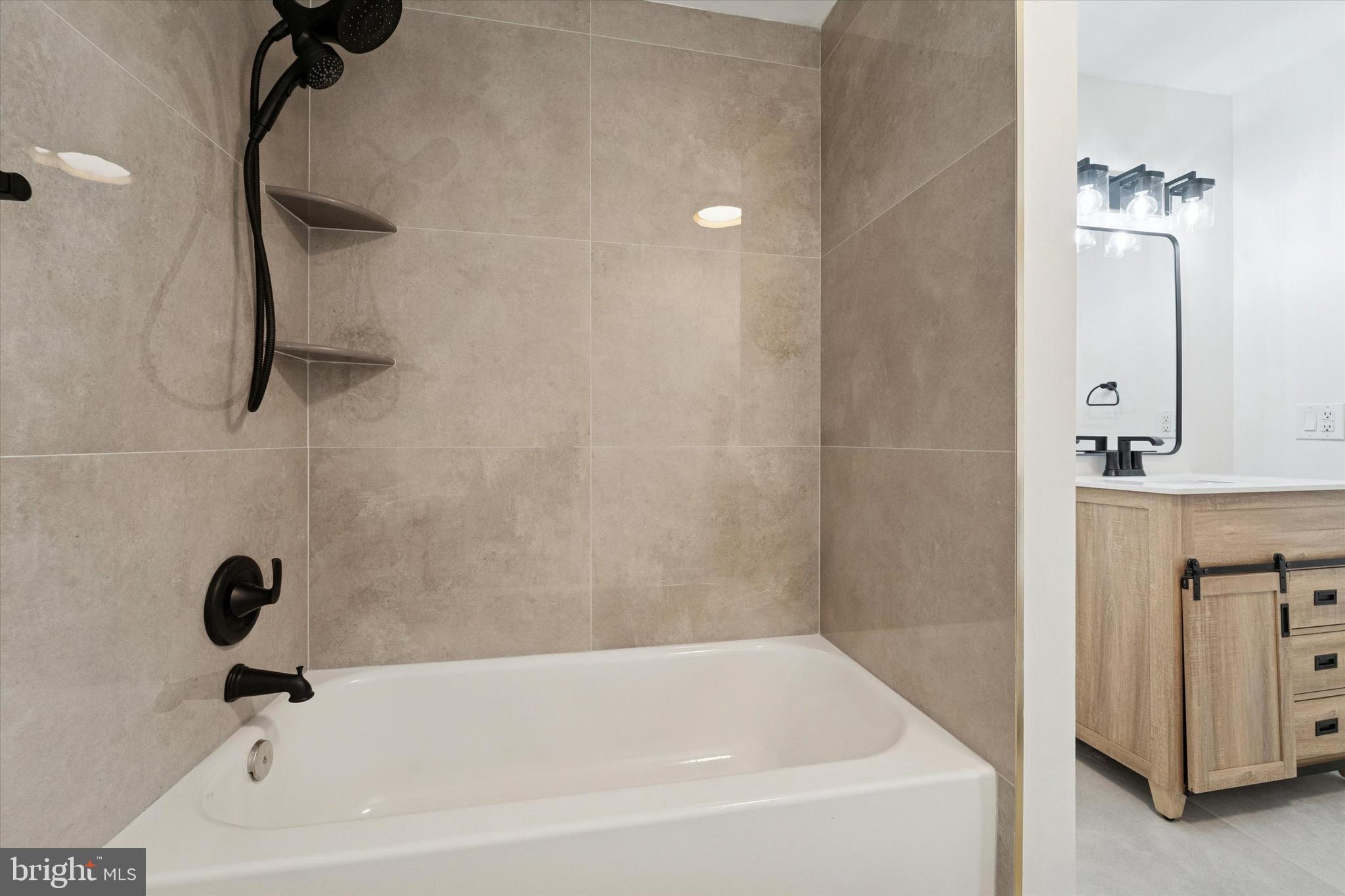 2353 East Huntingdon Street Philadelphia, PA 19125 - Photo 34 of 42 a bathroom with a tub a sink and a shower