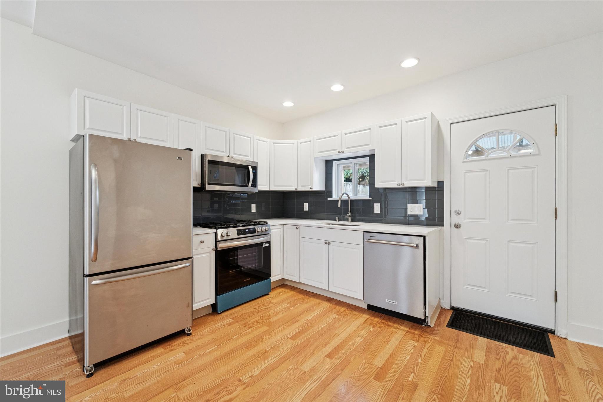2353 East Huntingdon Street Philadelphia, PA 19125 - Photo 7 of 42 a kitchen with stainless steel appliances granite countertop a refrigerator sink and stove