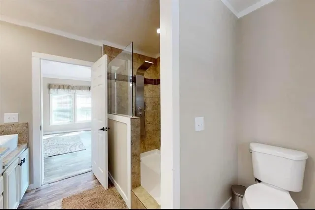 a bathroom with a toilet and a glass door