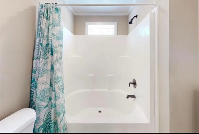 a bathroom with a bathtub and shower