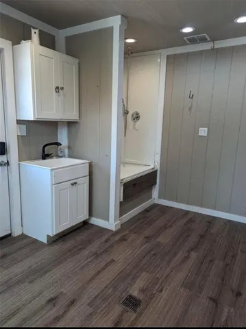 a view of cabinets and wooden floor