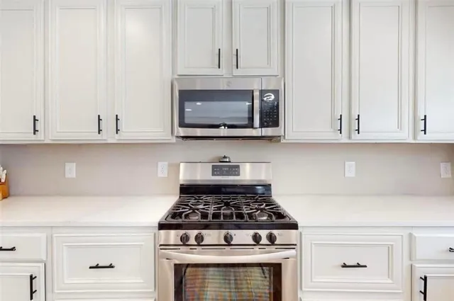 a stove top oven sitting inside of a kitchen