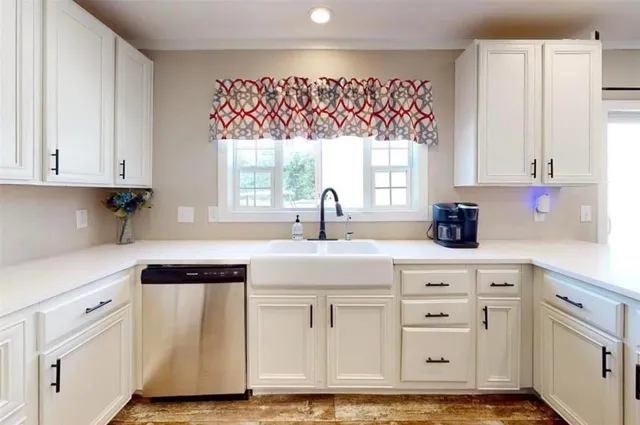 a kitchen with white cabinets and white appliances
