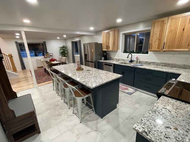 2807 North Ogden Canyon Road Eden, UT 84310 - Photo 9 of 72 Kitchen featuring a large island with granite countertops, recessed lighting, wood-finish upper cabinetry, and dark lower cabinetry