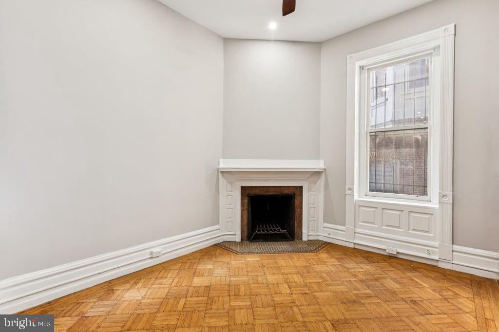 2101 Spruce Street, Unit 2R Philadelphia, PA 19103 - Photo 17 of 28 a view of an empty room with a fireplace and a window