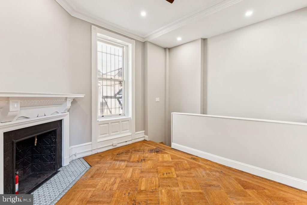 2101 Spruce Street, Unit 2R Philadelphia, PA 19103 - Photo 23 of 28 a view of empty room with wooden floor and fireplace