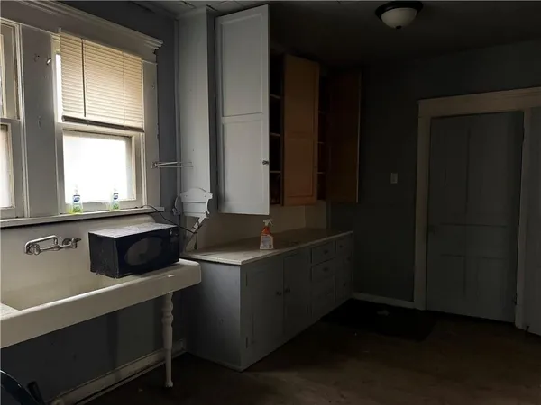 a room with a window and cabinets
