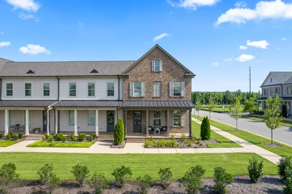 a front view of a house with a yard table and chairs