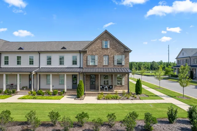a front view of a house with a yard table and chairs