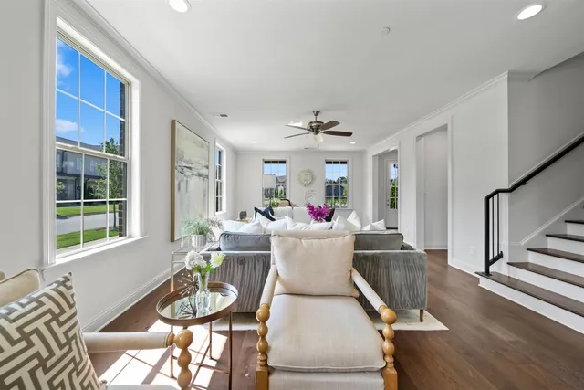 a living room with furniture and a dining table