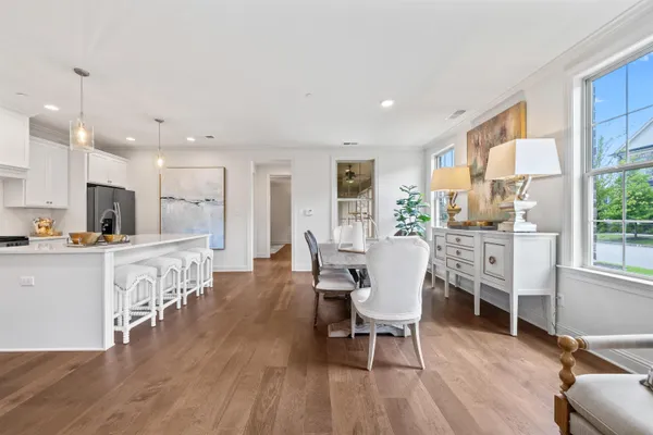 a dining room with furniture and wooden floor