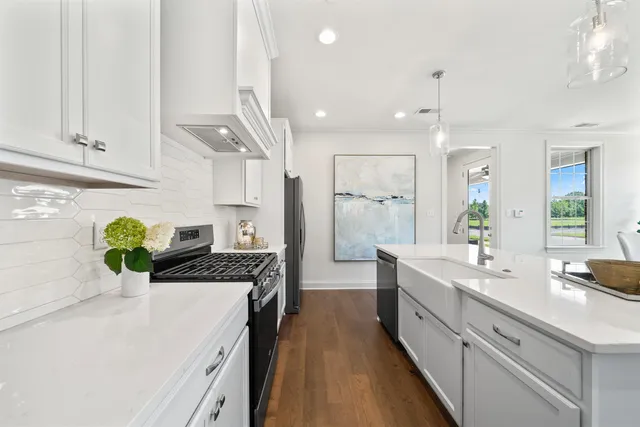 a large kitchen with a sink and refrigerator
