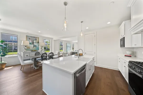 a kitchen with a sink a counter and chairs