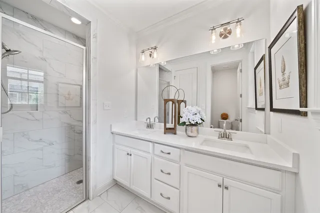 a bathroom with double sink and a mirror