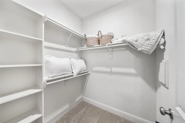 a view of cabinets and utility room with racks on the wall
