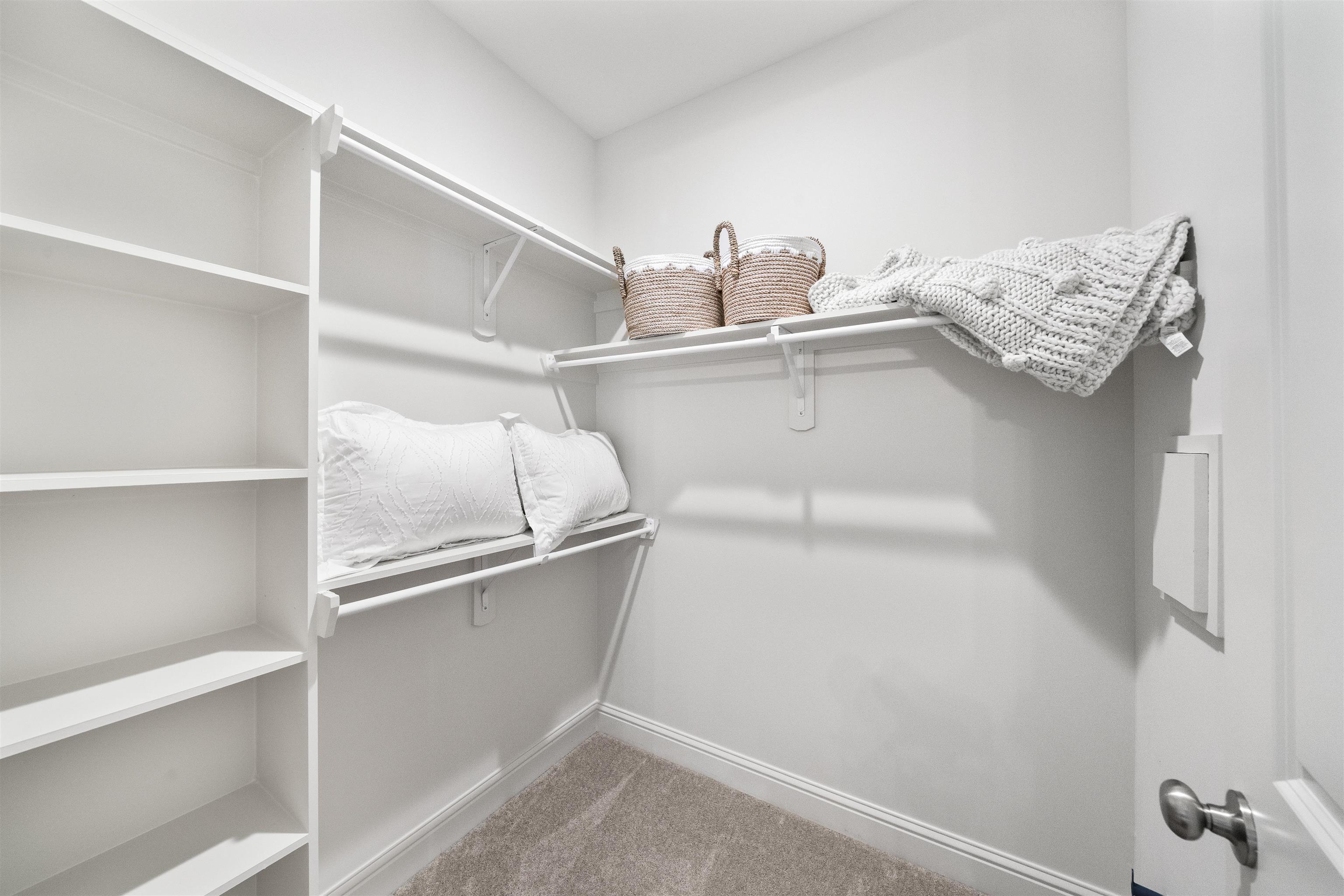 877 Ufton Alley Collierville, TN 38017 - Photo 25 of 36 a view of cabinets and utility room with racks on the wall
