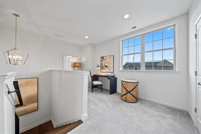 a view of a livingroom with furniture and windows