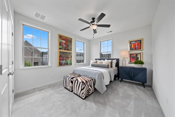a spacious bedroom with a bed and a large window