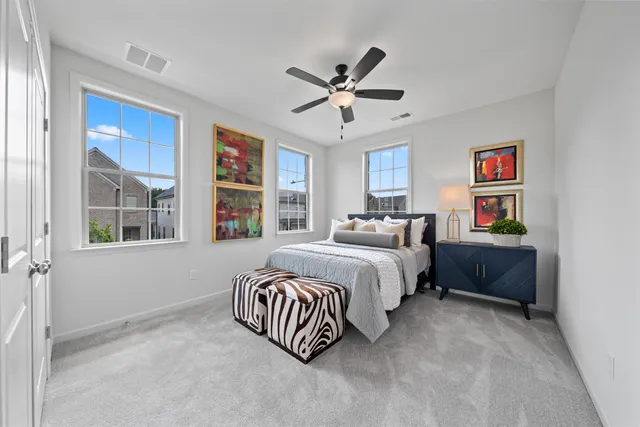 a spacious bedroom with a bed and a large window