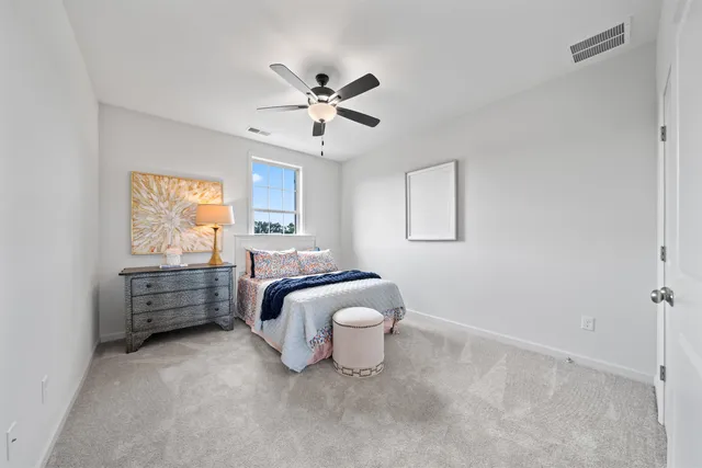 a spacious bedroom with a bed and a window