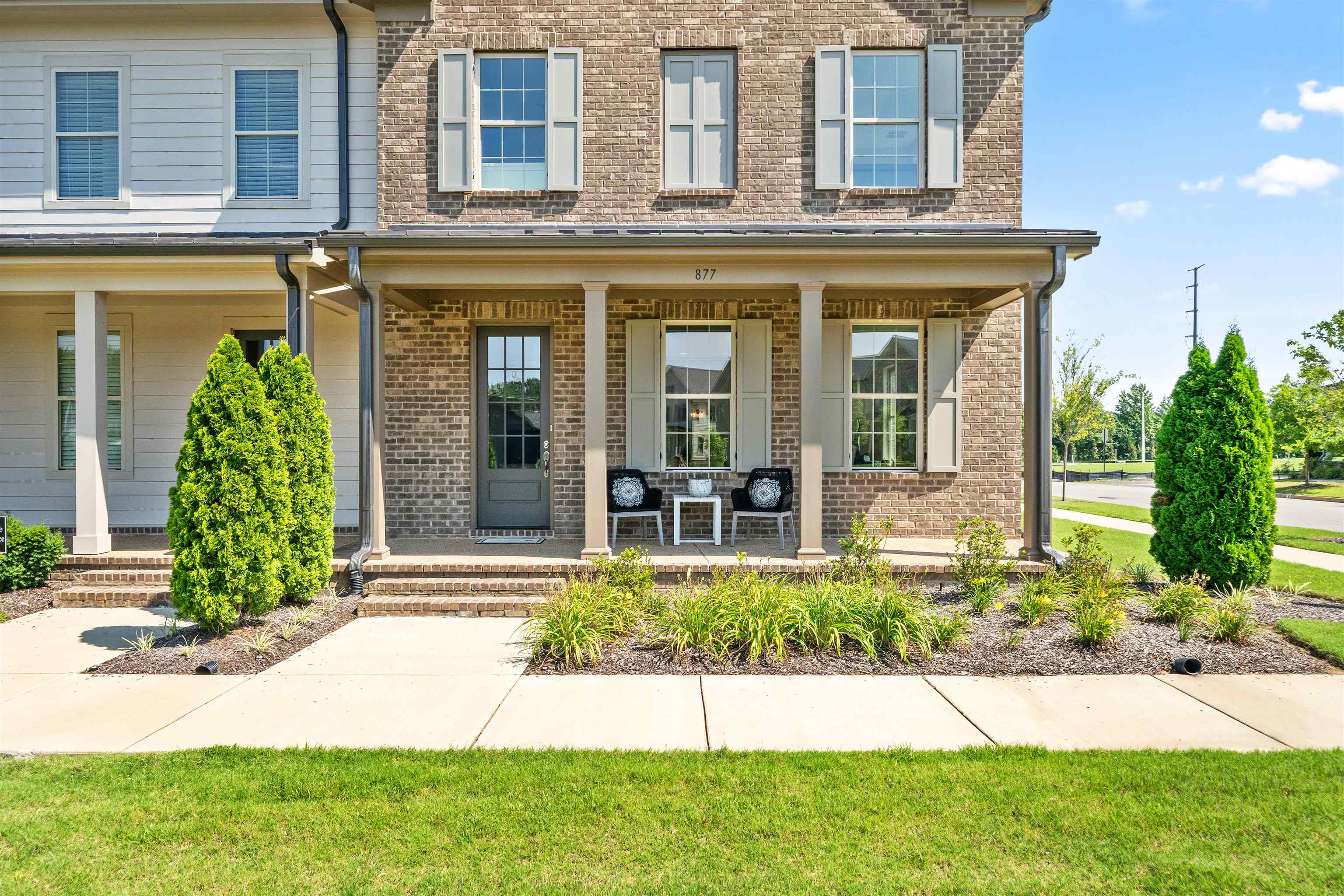 877 Ufton Alley Collierville, TN 38017 - Photo 5 of 36 front view of a brick house with a yard