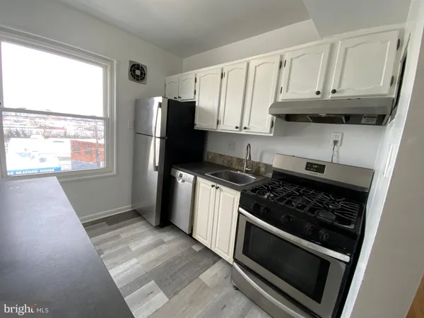 a kitchen with wooden cabinets and a stove top oven