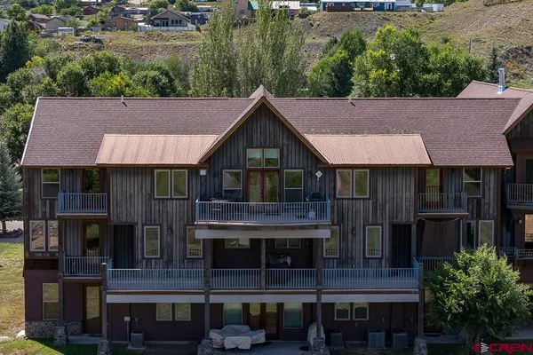 a aerial view of a house and a yard and car parked